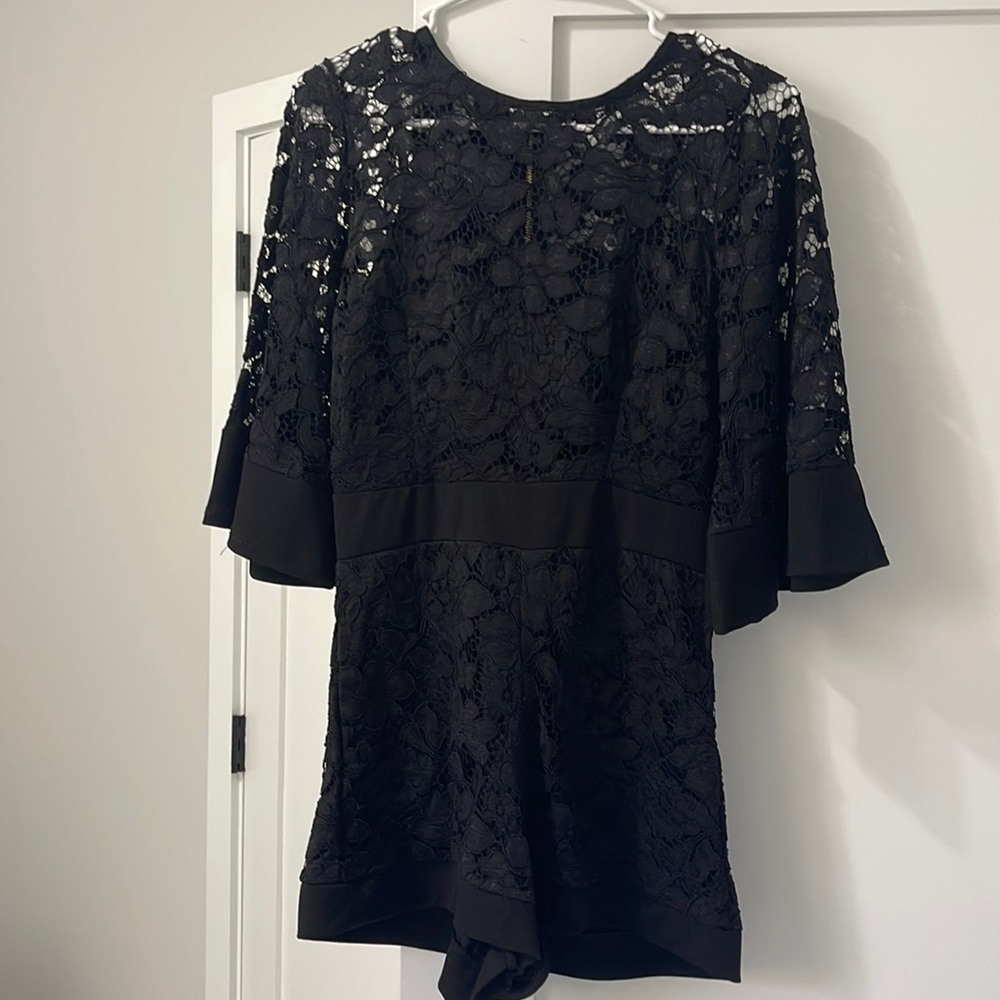 Black lace shorts jumper with gold zipper down the back.